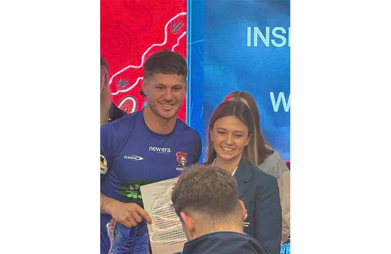 Students present Newcastle Knights players with hand-painted boots in honour of Indigenous Round. Photos: CMCC Facebook.