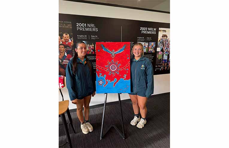 Students present Newcastle Knights players with hand-painted boots in honour of Indigenous Round. Photos: CMCC Facebook.