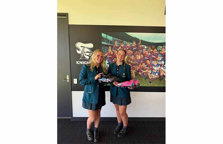 Students present Newcastle Knights players with hand-painted boots in honour of Indigenous Round. Photos: CMCC Facebook.