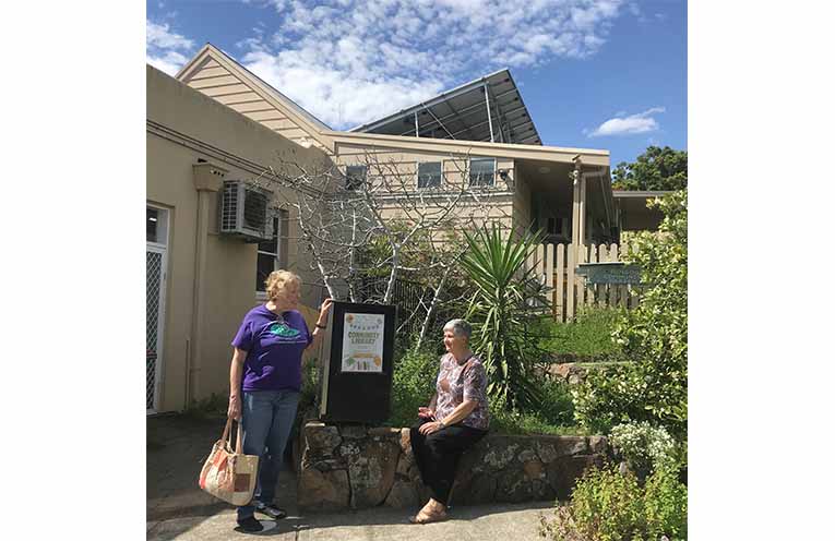 The rooftop solar on top of Dungog Shire Community Centre, with volunteers Rachel Stokes and Laurel McBriarty. Photo: Ken Rubeli.