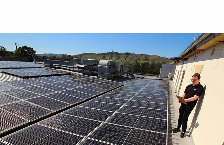The rooftop solar on top of Dungog Shire Community Centre, with volunteers Rachel Stokes and Laurel McBriarty. Photo: Ken Rubeli.