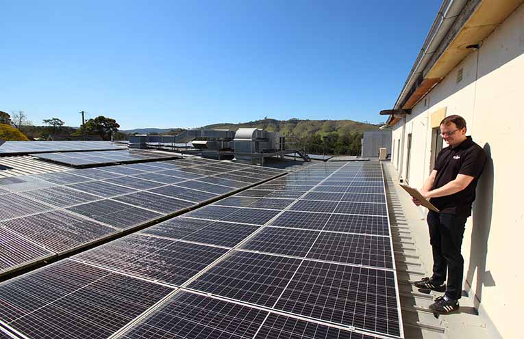 The rooftop solar on top of Dungog Shire Community Centre, with volunteers Rachel Stokes and Laurel McBriarty. Photo: Ken Rubeli.