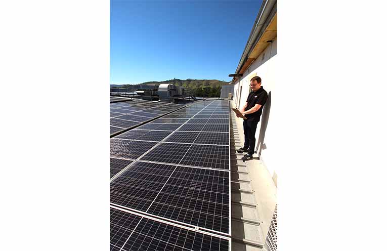 The rooftop solar on top of Dungog Shire Community Centre, with volunteers Rachel Stokes and Laurel McBriarty. Photo: Ken Rubeli.