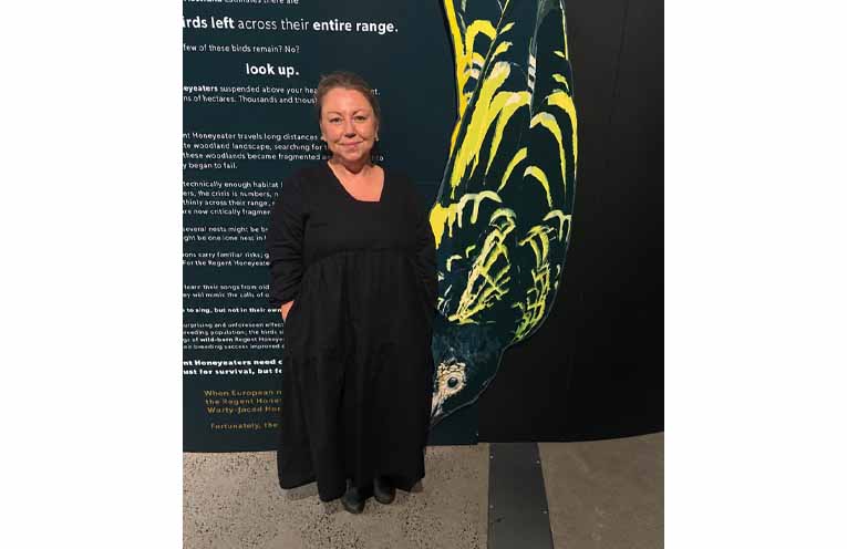 Nicole Chaffey, curator and director of Murrook Cultural Centre, with the striking Regent Honeyeater display she created. Photo: Althea Guinsberg.