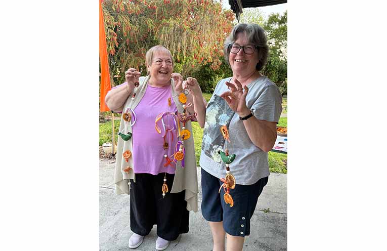 Madryn and Melissa, two Paterson locals who attended an orange garland-making workshop at the Hub & Harvest. Photo: Eleesha Pereira.